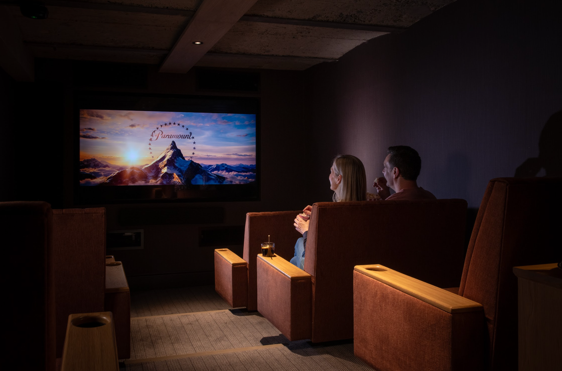 A couple in a cosy cinema, enjoying a movie