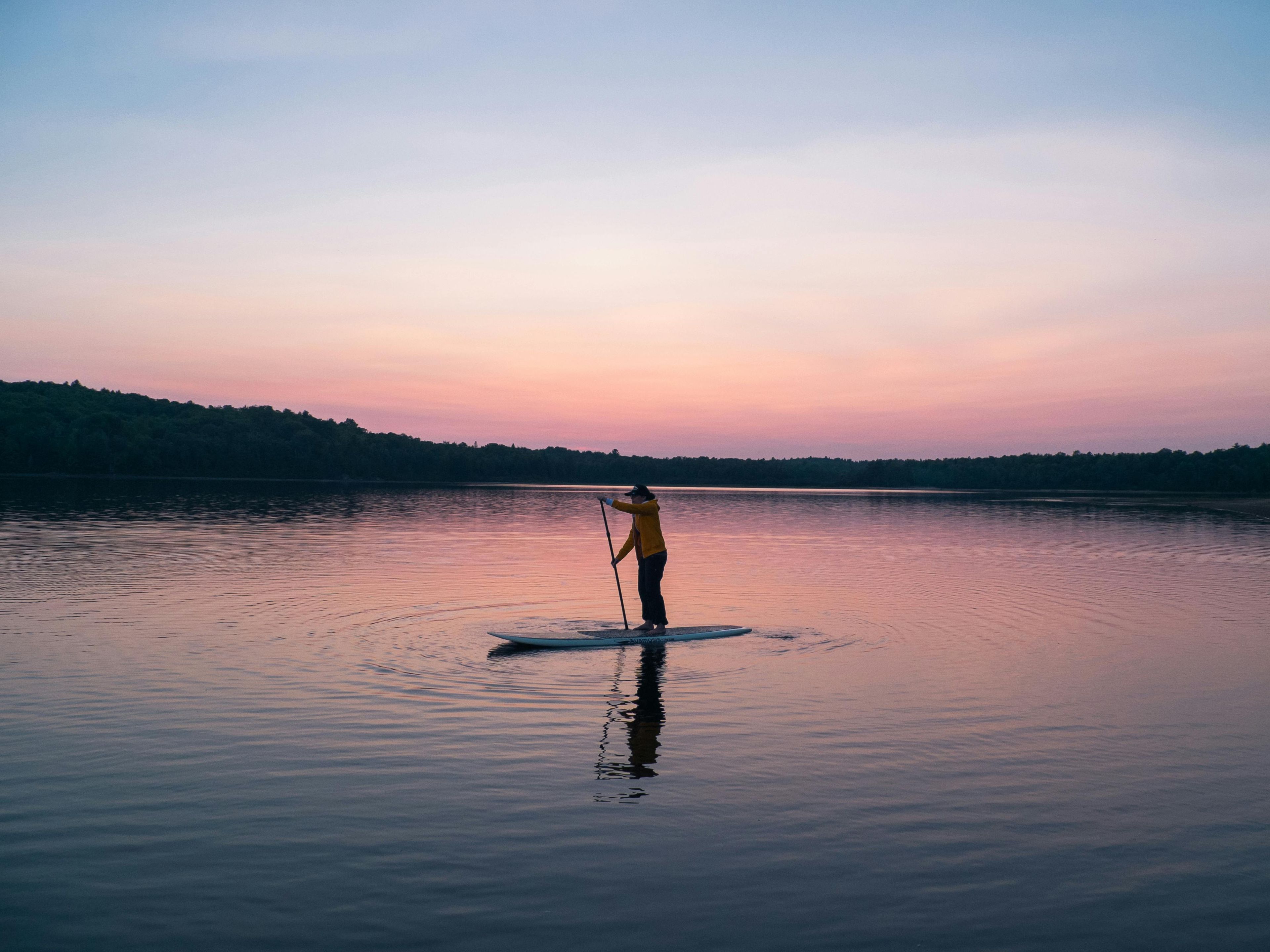 Paddle boarder at sunset