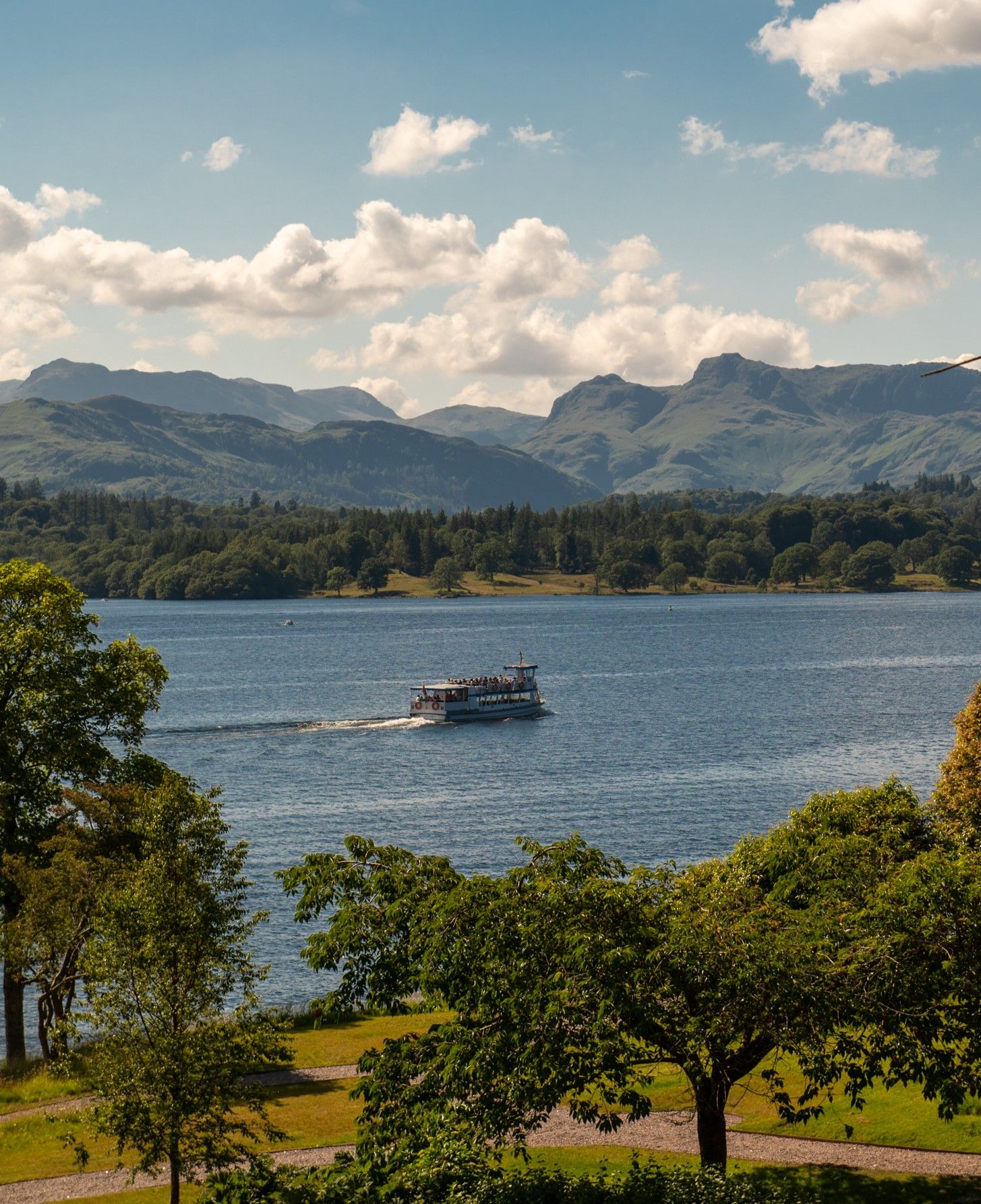 Boat on Lake Windermere in front of Langdale Chase hotel