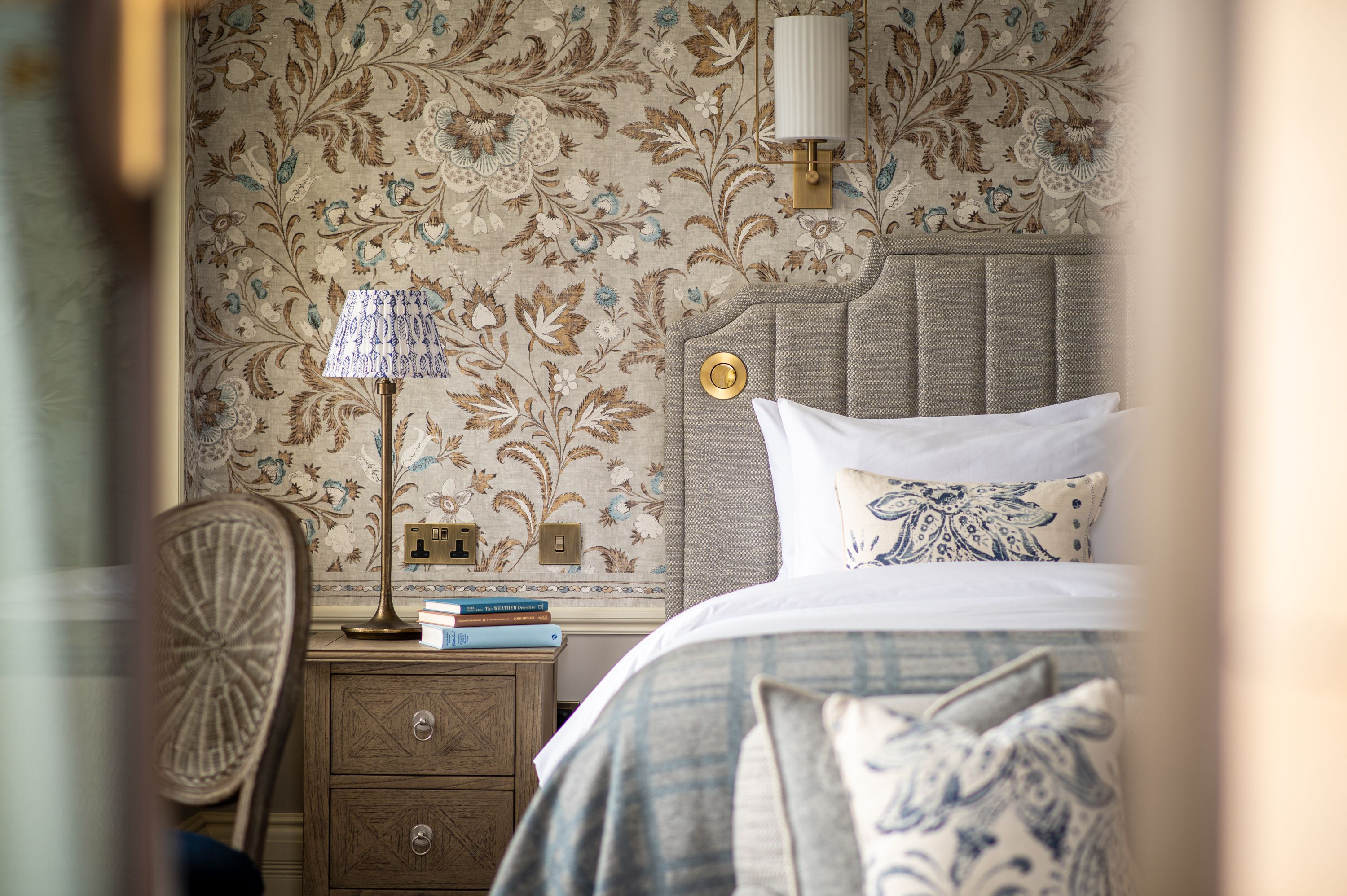 A spacious bedroom with a bedside table